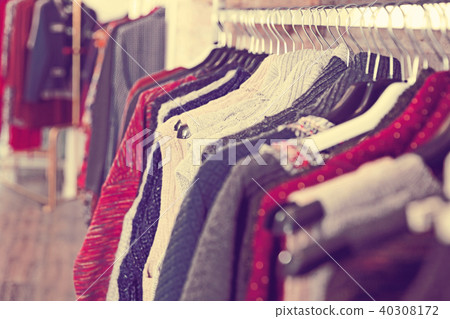 Colorful clothes hanging on hangers in the store Colorful clothes hanging on hangers in the store 40308172
