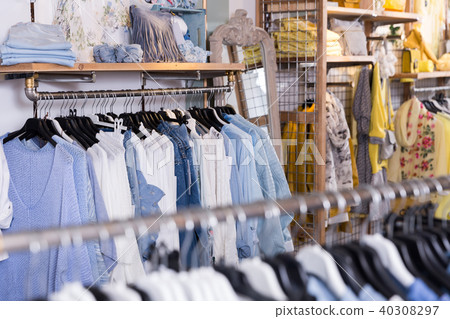 Different colored clothes in the modern shopping centre Different colored clothes in the modern shopping centre 40308297