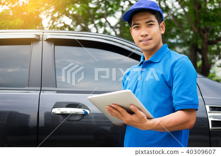 Delivery man checking document list on clipboard outdoor and Car Delivery man checking document list on clipboard outdoor and Car 40309607