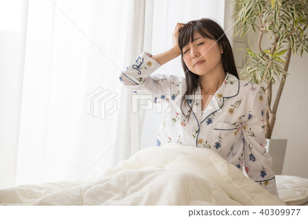 Sleepless young woman getting up image Sleepless young woman getting up image 40309977
