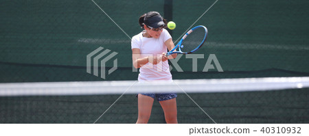 Women's junior tennis player hitting backhand 40310932