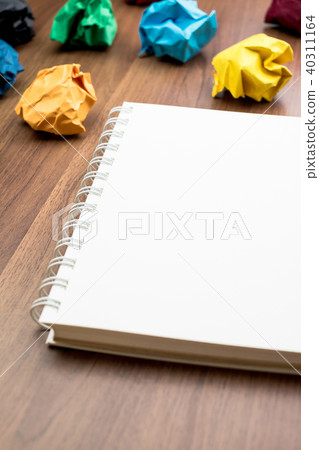 open white book  with group of colorful crumple 40311164