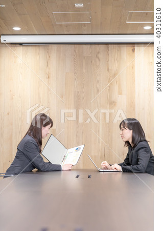 Two women in suits in a meeting room 40311610