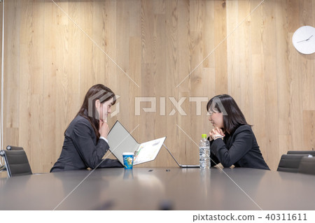 Two women in suits in a meeting room 40311611