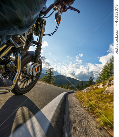 Motorcycle rider driving in Alps Motorcycle rider driving in Alps 40312079