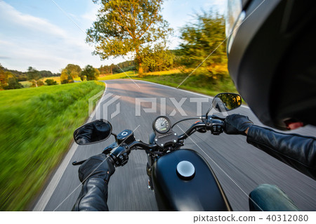 POV of motorbiker holding steering bar POV of motorbiker holding steering bar 40312080