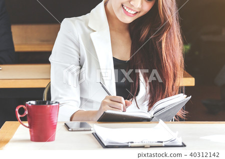Businesswoman working at a coffee shop Businesswoman working at a coffee shop 40312142