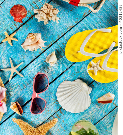 Beach accessories placed on blue wooden planks Beach accessories placed on blue wooden planks 40312485
