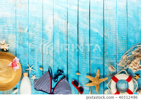 Beach accessories placed on blue wooden planks Beach accessories placed on blue wooden planks 40312496