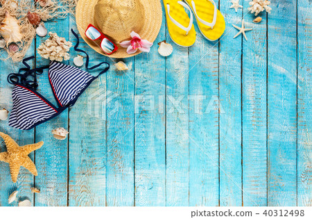 Beach accessories placed on blue wooden planks Beach accessories placed on blue wooden planks 40312498