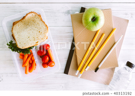 Lunch box with vegetables and slice of bread  40313192