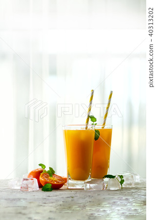 Fresh orange juice, mint and ice on white 40313202