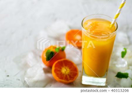 Fresh tangerine juice in glass on white concrete 40313206