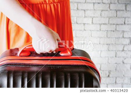 Woman holding suitcase Woman holding suitcase 40313420