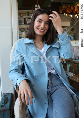 Attractive young woman sitting in cafe. Attractive young woman sitting in cafe. 40314290