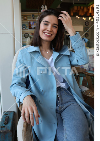 Attractive young woman sitting in cafe. Attractive young woman sitting in cafe. 40314291