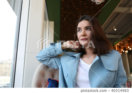 Attractive young woman sitting in cafe. 40314983
