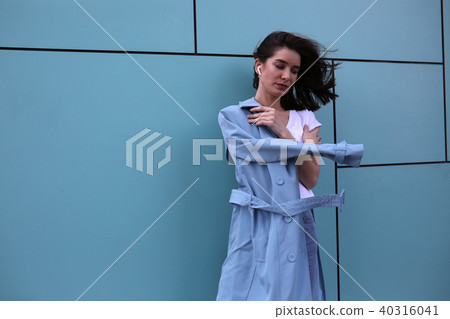 Attractive young woman on a turquoise background. 40316041
