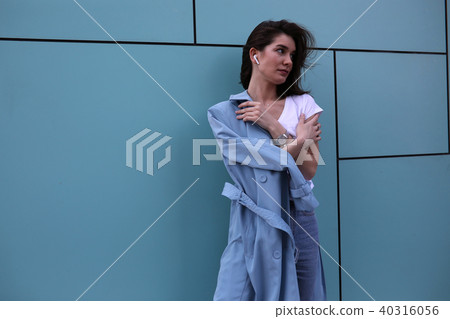 Attractive young woman on a turquoise background. 40316056