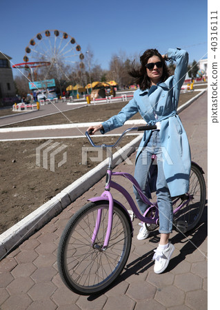 Stylish young woman riding a bicycle. 40316111