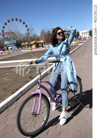 Stylish young woman riding a bicycle. 40316115
