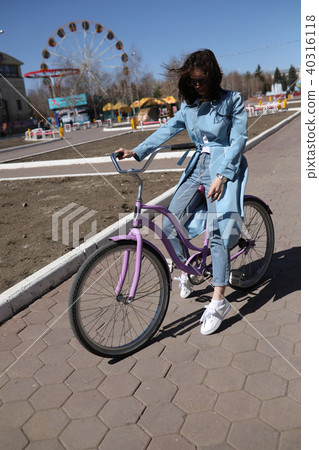 Stylish young woman riding a bicycle. 40316118