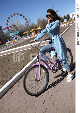Stylish young woman riding a bicycle. 40316146