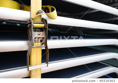 Yellow ratchet straps tie many goods 40316363