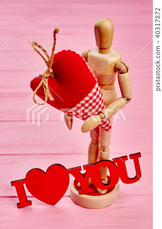 Wooden dummy mannequin in love holding heart. 40317872