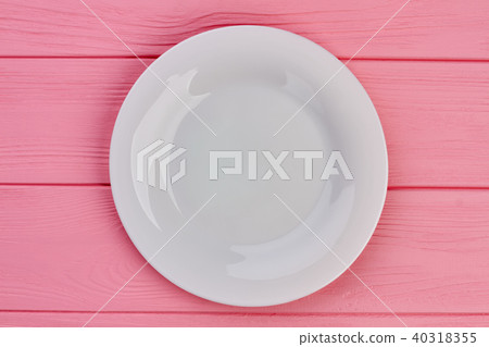 White empty plate on wooden background. 40318355