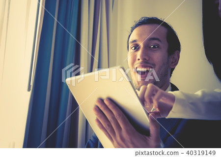 Business man is wow with what on tablet 40319149