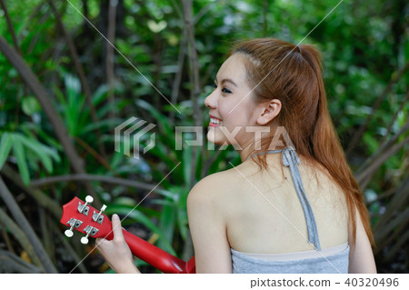 Music Concepts. Asian girls playing Ukulele. Asian women relaxin 40320496