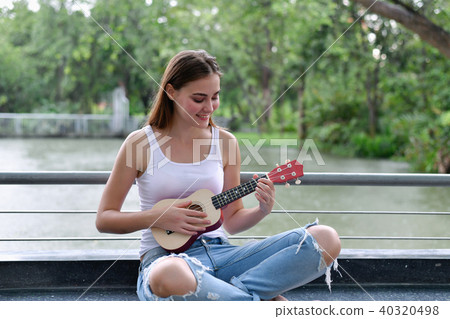 Music Concepts. beautiful girls playing Ukulele. women relaxing Music Concepts. beautiful girls playing Ukulele. women relaxing 40320498