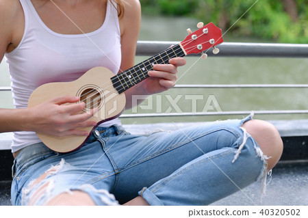 Music Concepts. beautiful girls playing Ukulele. women relaxing Music Concepts. beautiful girls playing Ukulele. women relaxing 40320502