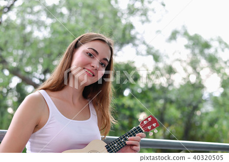 Music Concepts. beautiful girls playing Ukulele. women relaxing Music Concepts. beautiful girls playing Ukulele. women relaxing 40320505