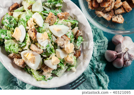 Caesar salad with cheese, eggs and croutons 40321095