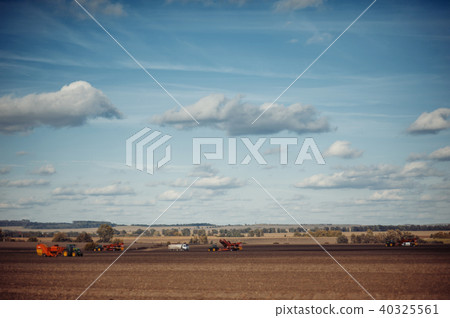 Tractor plowing up the field. 40325561