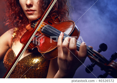 Violinist girl performs on stage. 40326572