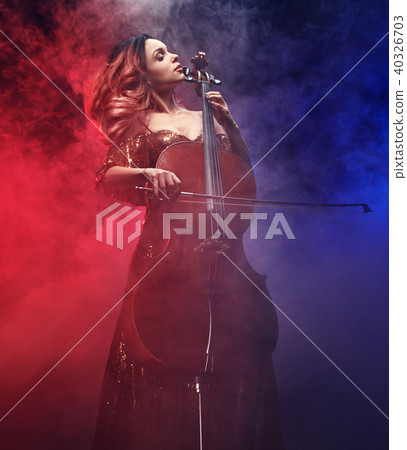 The cellist girl performs on stage. 40326703