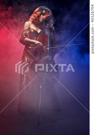The cellist girl performs on stage. 40326704