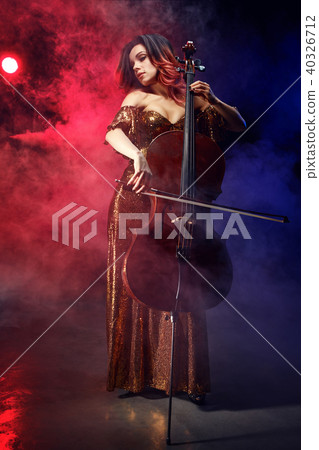 The cellist girl performs on stage. 40326712