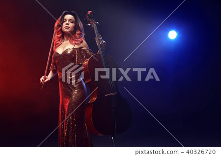 The cellist girl performs on stage. 40326720
