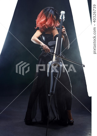 The cellist girl performs on stage. 40326739