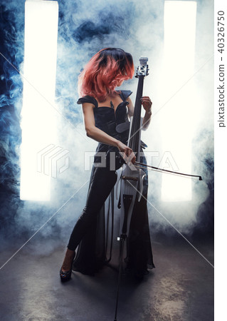 The cellist girl performs on stage. 40326750