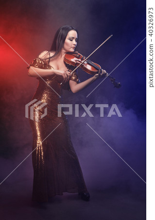 Violinist girl performs on stage. 40326973