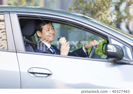 Businessman riding a car Businessman riding a car 40327465