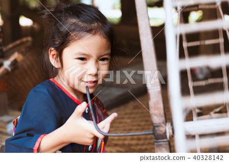 asian girl using traditional spinning wheel asian girl using traditional spinning wheel 40328142
