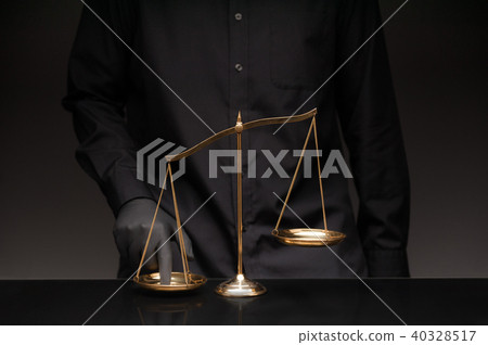 Man pressing the imbalance scale Man pressing the imbalance scale 40328517