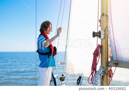 Young man sailing. Teenager boy on sea sail boat. Young man sailing. Teenager boy on sea sail boat. 40328682