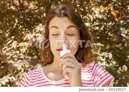 Girl drips blocked nose from allergy. Girl drips blocked nose from allergy. 40329027